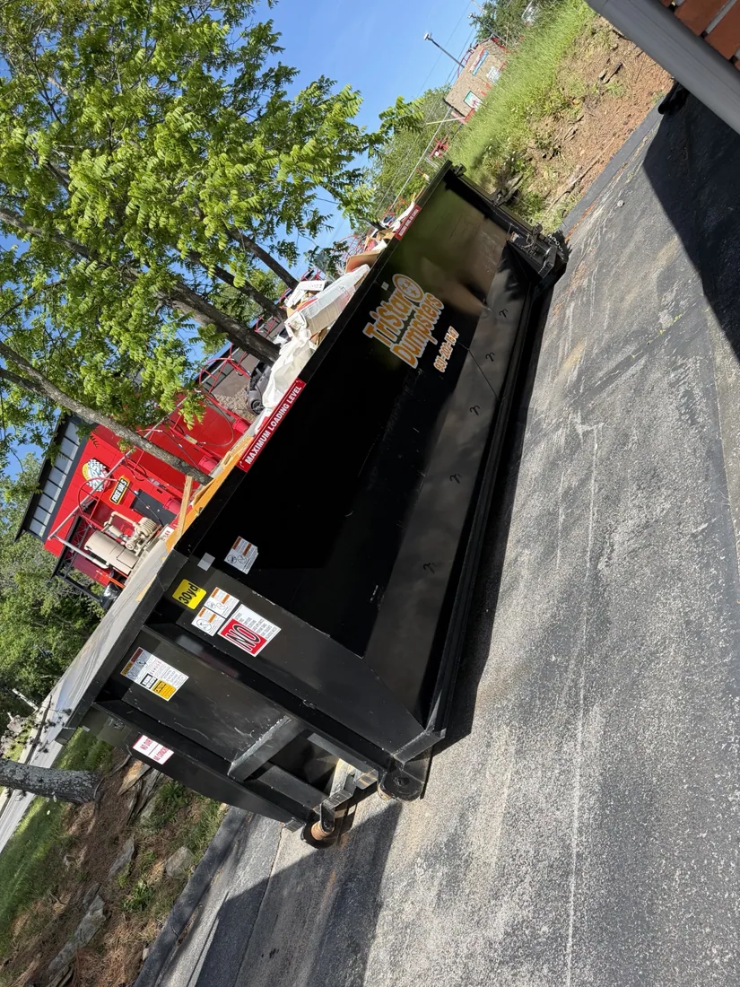 TriStar-branded dumpster on a driveway